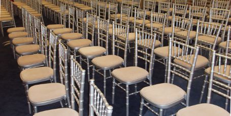 Silver Chiavari Chairs with Ivory coloured Seat Pads in rows