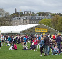 Festival Marquee at Park Event with Visitors Walking Past